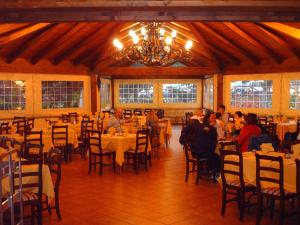 a group of people sitting at tables in a restaurant at Agriturismo Le Cannucceta in Castel San Pietro Romano +31 photos