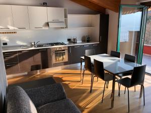 a kitchen and dining room with a table and chairs at La Valletta Suite in Dervio