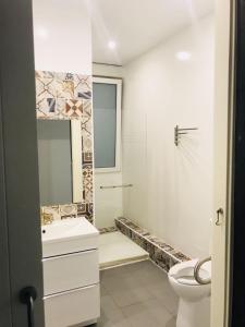 a white bathroom with a sink and a toilet at Apartamento Kasa Tomas Gros in San Sebastián +25 photos