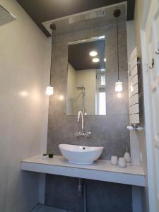 a bathroom with a white sink and a mirror at Art House in Tbilisi City