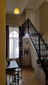 a staircase in a room with a table and a dining room at Art House in Tbilisi City