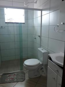 a white bathroom with a toilet and a sink at Apartamentos de Penha in Penha