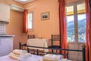 a bedroom with a table and a window with a view at Villa View Studios in Andros