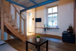 Televízia a/alebo spoločenská miestnosť v ubytovaní Apartament Berka 9