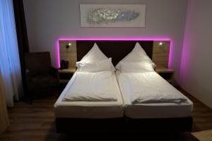 
two beds in a room with a white bedspread at Minx – CityHotels in Aachen
