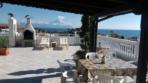 a patio with a table and chairs and the ocean at Haus Despina in Sarti