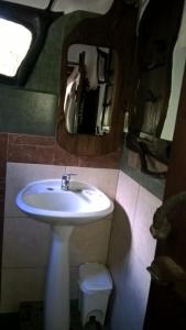a bathroom with a sink and a mirror at Casita de Duendes in Salinas 