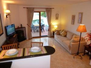 a living room with a couch and a table at 1 Bed Traditional Holiday Rental Cottage Oasis Capistrano Nerja Spain in Nerja