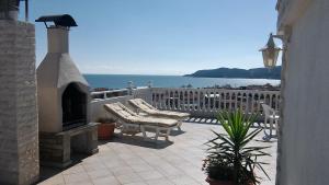 a patio with two chairs and a fireplace at Haus Despina in Sarti