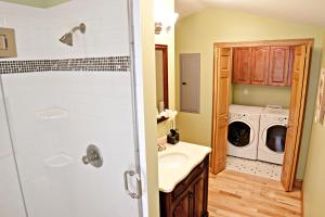 a bathroom with a sink and a washer and dryer at DeSoto Beach Vacation Properties in Tybee Island