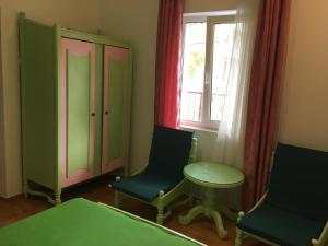 a room with two chairs and a table and a window at Apartamente Mitu in Eforie Nord
