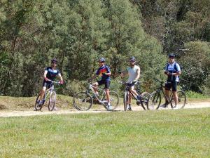 a group of people riding bikes on a dirt road at Atalho Guest House in Cunha