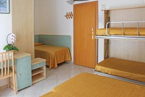 a small room with two bunk beds and a door at Hotel Flora in Bellaria-Igea Marina