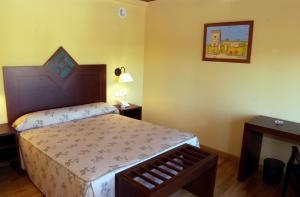 um quarto com uma cama e uma fotografia na parede em Hotel Spa La Casa Mudéjar em Segóvia