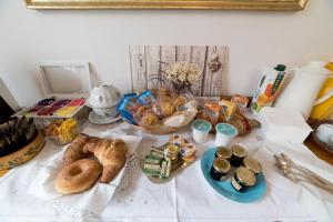 a table topped with bread and pastries on a table at B&B" del Castello" in Roccascalegna