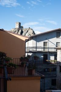 a view of a building with a hill in the background at B&B" del Castello" in Roccascalegna