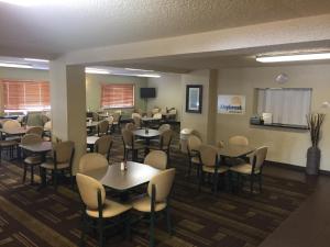 a restaurant with tables and chairs in a room at Days Inn by Wyndham Bismarck in Bismarck