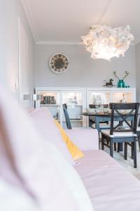 a living room with a table and a clock on the wall at Luxury City Centre Apartment in Bucharest