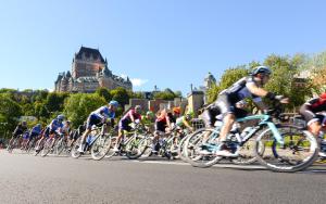 a group of people riding bikes down a street at Auberge Jeunesse La Belle Planete Backpackers Hostel in Quebec City