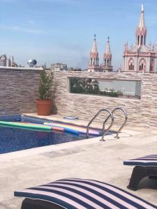 a swimming pool on the roof of a building at Hotel Everest in Córdoba