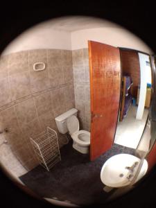 a small bathroom with a toilet and a sink at Rocio de Luna in Mina Clavero