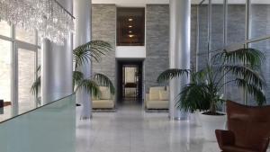 a lobby with chairs and plants in a building at Bellagio Tower in Punta del Este +36 photos