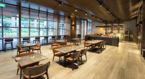 - un restaurant avec des tables et des chaises dans une salle dotée de fenêtres dans l'établissement 30 Bencoolen, à Singapour