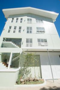 
a large white building with a window at Shore Time Dormitel in Boracay
