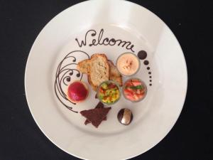 a white plate topped with different types of food at Selva Verde Lodge in Sarapiquí