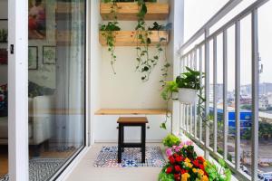 a balcony with a bench and flowers on it at Kirakuan Luxury 2BR Pool/Gym in Ho Chi Minh City