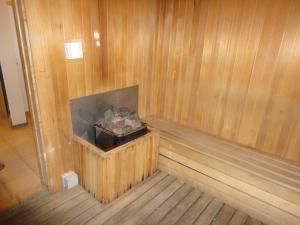 a wood paneled room with a fireplace in a sauna at FnF Suite @ Time Square in Kuala Lumpur