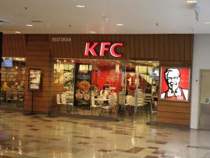 a kfc restaurant with tables and chairs in a mall at FnF Suite @ Time Square in Kuala Lumpur