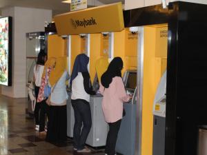 a group of people standing at a pay station at FnF Suite @ Time Square in Kuala Lumpur