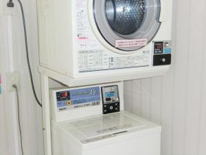 a washing machine sitting on top of a washer at Hotel Park Avenue in Tokyo +9 photos