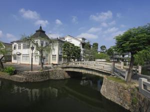 un ponte su un fiume in una città con edifici di APA Hotel Kurashiki Ekimae a Kurashiki