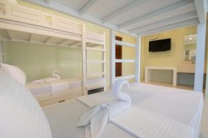 
a bedroom with a bed and a dresser at Shore Time Dormitel in Boracay
