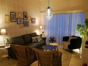 a living room with a couch and chairs at Cosy Cameron in Cameron Highlands