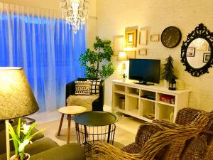 a living room with a couch and a television at Cosy Cameron in Cameron Highlands