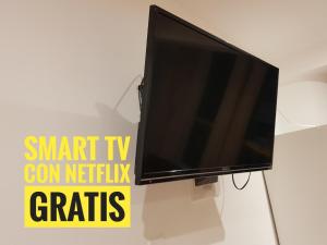 a flat screen tv sitting on a white wall at Le Prince Tacna in Tacna