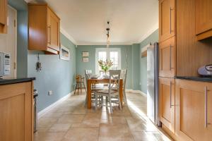 a kitchen and dining room with a table and chairs at Tolly House in Wells next the Sea