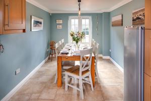 a kitchen and dining room with a table and chairs at Tolly House in Wells next the Sea