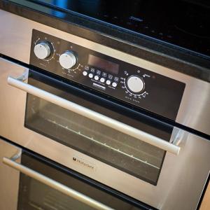 a close up of an oven with its door open at Tolly House in Wells next the Sea