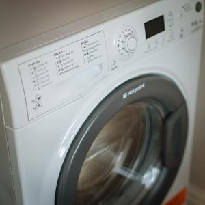 a white washing machine sitting in a room at Tolly House in Wells next the Sea