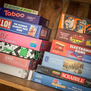 a pile of books sitting on a table at Tolly House in Wells next the Sea