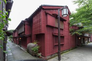 a red building on the side of a street at Machiya Kanazawa Kikunoya in Kanazawa +17 photos