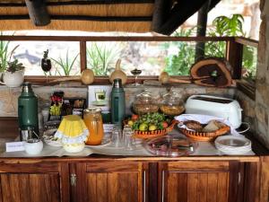 a counter with fruits and vegetables in baskets on it at Sophienhof Lodge in Outjo