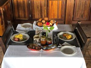 a table with several plates of food on it at Sophienhof Lodge in Outjo
