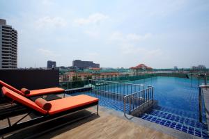a balcony with a swimming pool on top of a building at Nova Express Pattaya Hotel in Pattaya Central