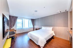 Postel nebo postele na pokoji v ubytování The First70 Hotel