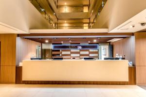 a lobby of a dental office with a reception counter at The First70 Hotel in Seogwipo